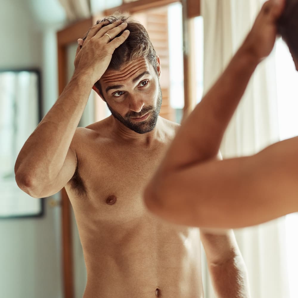 man checking out his hair