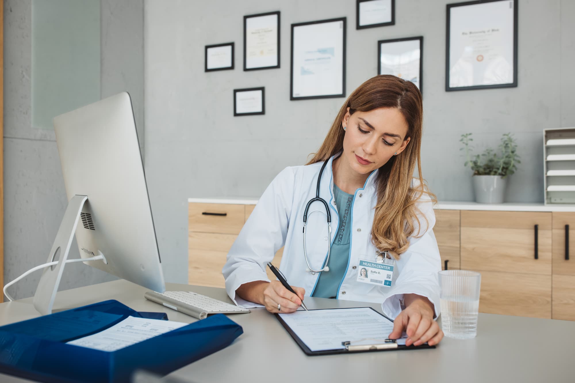 Female Doctor writing at her desk